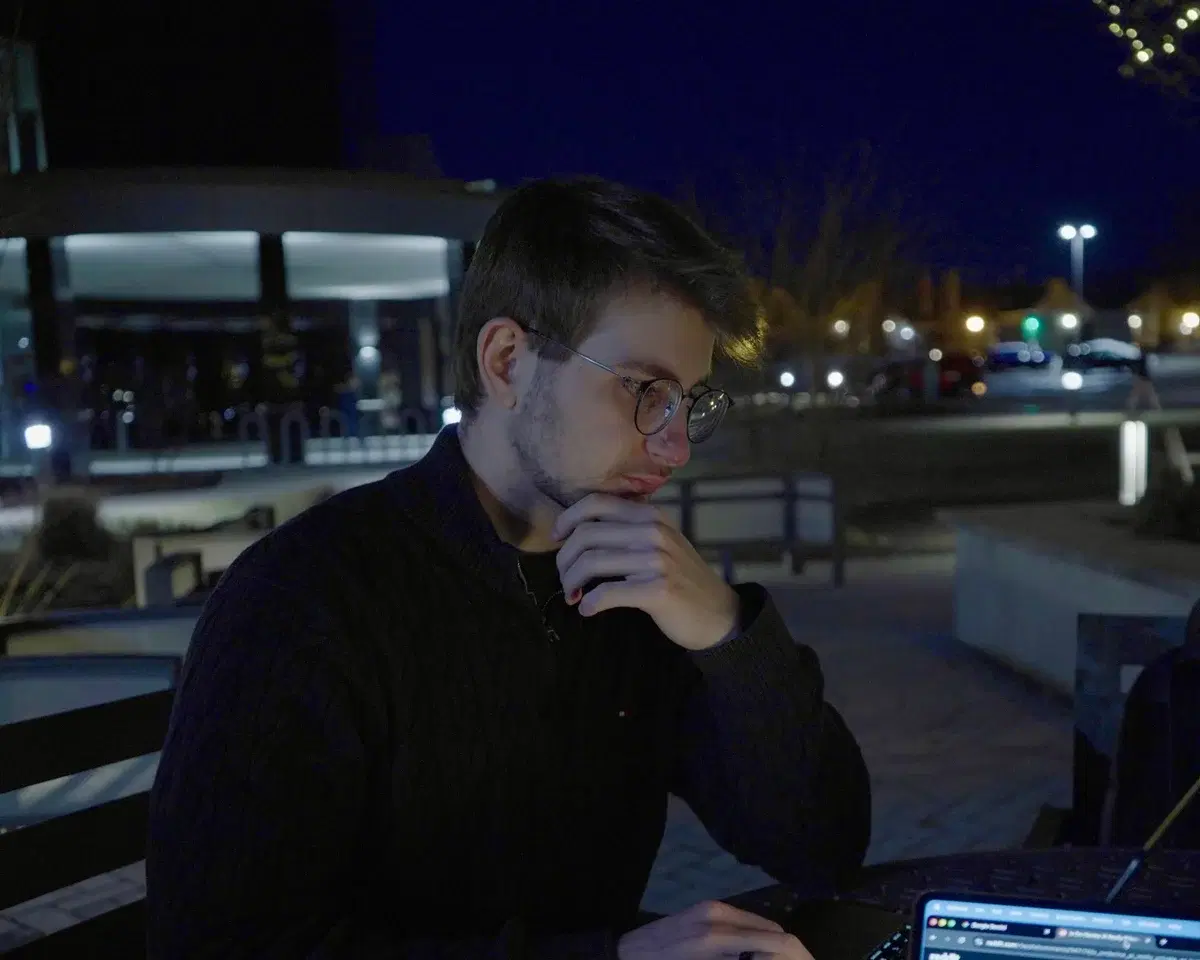 Working at a laptop outdoors in the evening